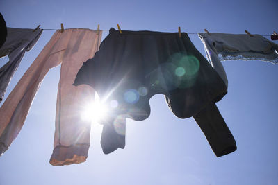 Low angle view of flags against clear sky