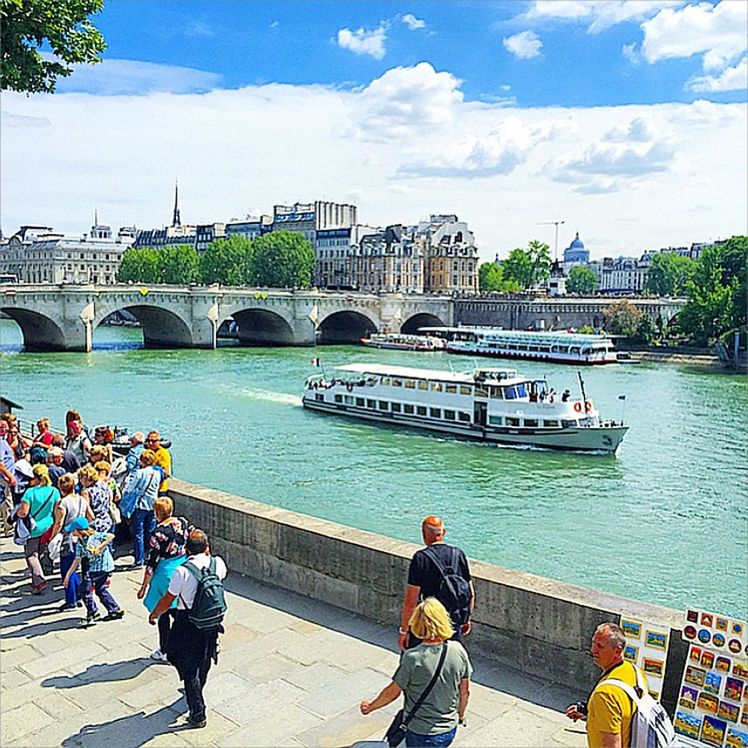 architecture, built structure, water, building exterior, lifestyles, men, person, leisure activity, sky, river, bridge - man made structure, railing, connection, city, rear view, blue, day, large group of people, tourism