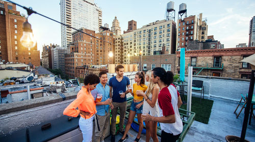 People standing on city against sky