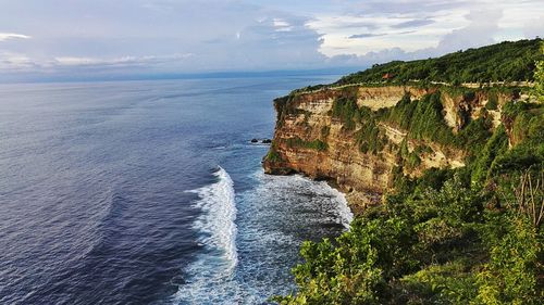 Scenic view of cliff by sea