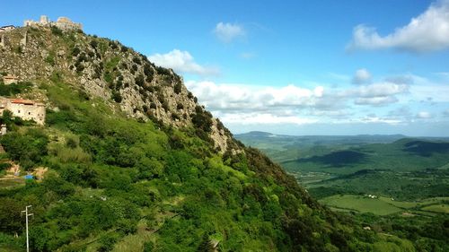 Scenic view of mountains against blue sky