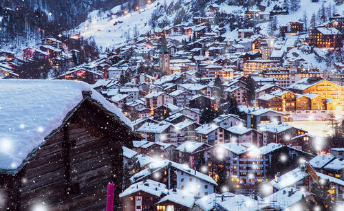 High angle view of snow covered buildings in city