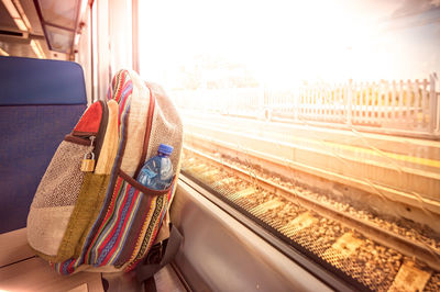 Rear view of woman in train at railroad station