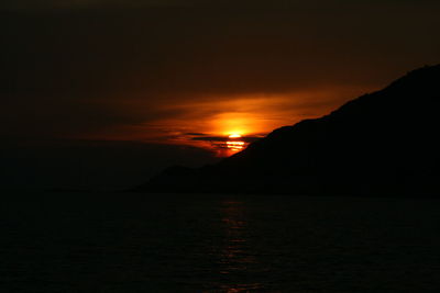 Scenic view of sea against romantic sky at sunset