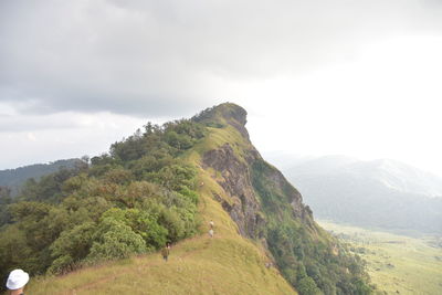 Scenic view of mountain against cloudy sky