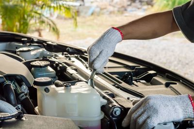 Cropped hand of man driving car
