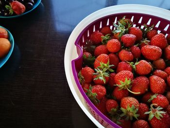 High angle view of strawberries in bowl on table