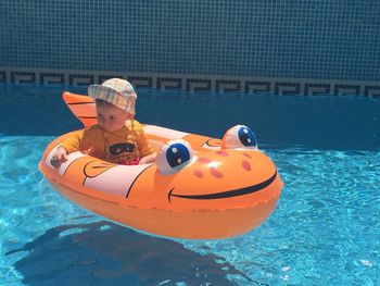 Side view of smiling boy in swimming pool