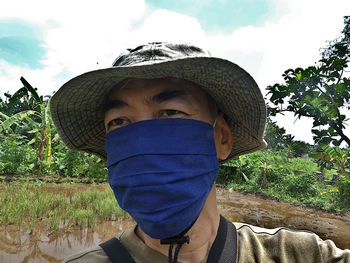 Portrait of man wearing hat against sky