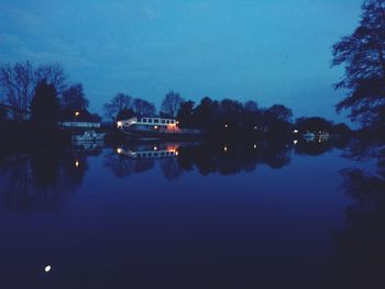 Scenic view of lake against sky at dusk