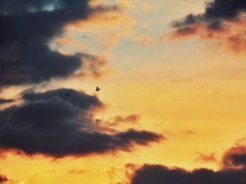 Low angle view of cloudy sky at sunset