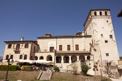 Low angle view of historical building against clear blue sky