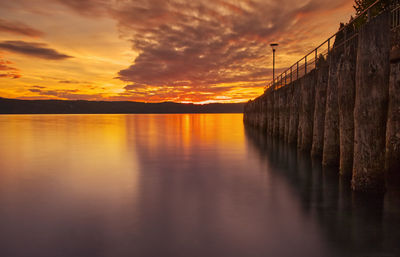 Scenic view of sea against orange sky