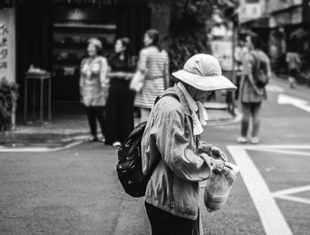 Woman standing on city street