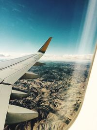 Cropped image of airplane flying over landscape