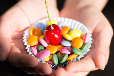 Close-up of person holding candies