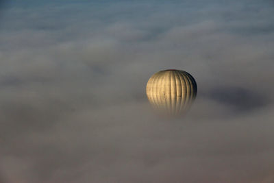 Hot air balloon amidst clouds 