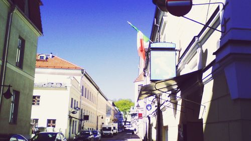 Cars parked in front of building against sky