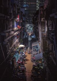 High angle view of street amidst buildings in city at night
