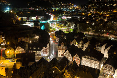 Aerial view of illuminated cityscape against sky at night