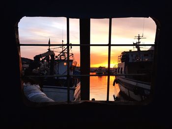 Boats in river at sunset