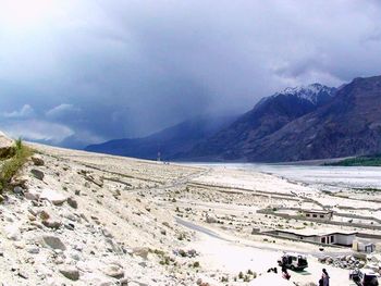 Scenic view of mountains against cloudy sky