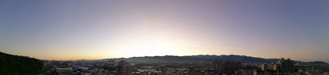 Aerial view of townscape against sky at sunset