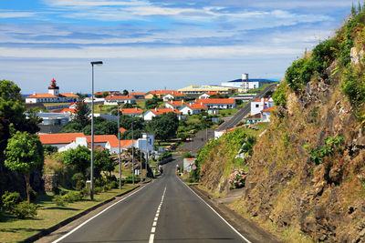 Road by town against sky