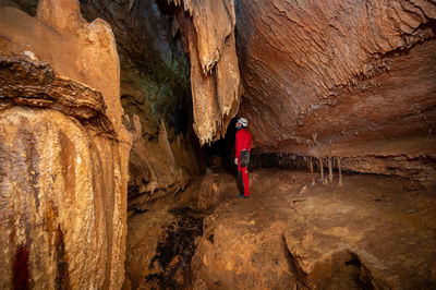 Rear view of man climbing on rock