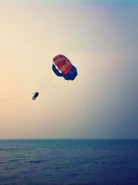 Hot air balloons flying over sea