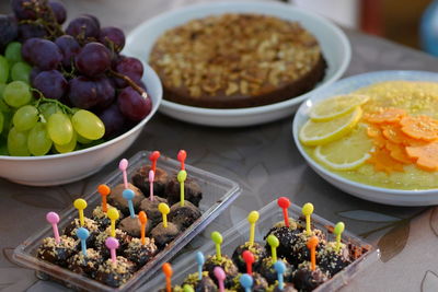 High angle view of fruits and dessert in bowl on table