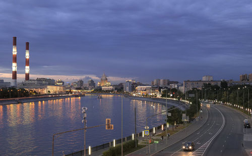 High angle view of illuminated bridge over river against sky at night