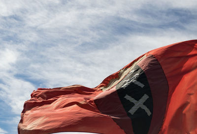 Low angle view of flag against sky