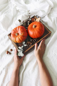 High angle view of woman hand on orange