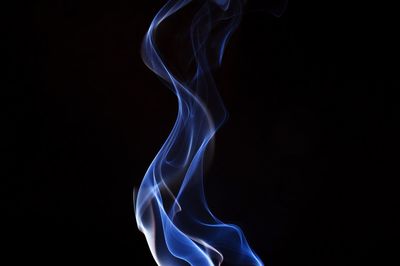 Close-up of blue smoke against black background