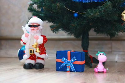 Close-up of christmas decorations on hardwood floor at home