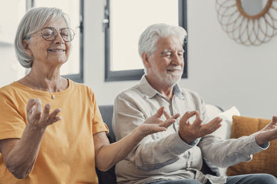 Portrait of senior couple sitting at home