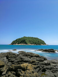 Scenic view of sea against clear blue sky