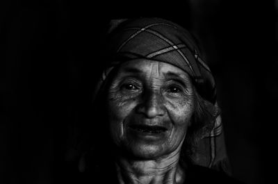 Portrait of mid adult man against black background