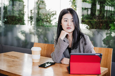 Portrait of young woman using mobile phone