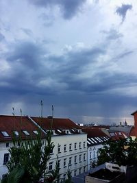 View of residential district against cloudy sky