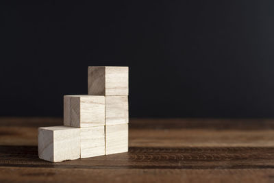 Close-up of wooden table against black background