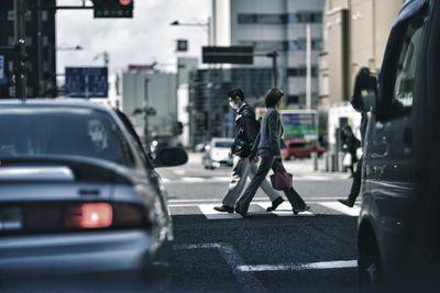 Side view of man walking on road in city