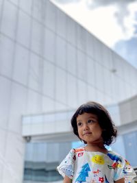 Portrait of a girl standing against wall