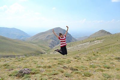 Full length of woman standing on grassy field