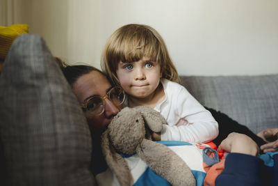 Mother with daughter on sofa