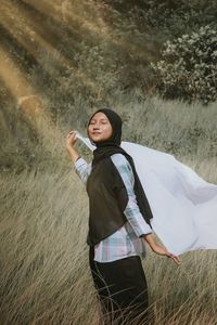 Young woman standing on field