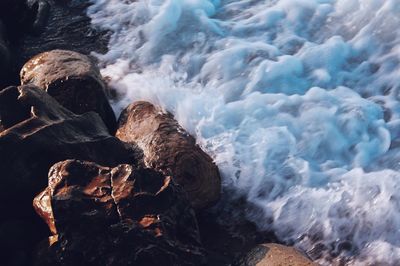 High angle view of surf on rocky shore