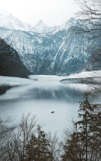 Scenic view of lake by snowcapped mountains