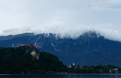 Scenic view of lake and mountains against sky